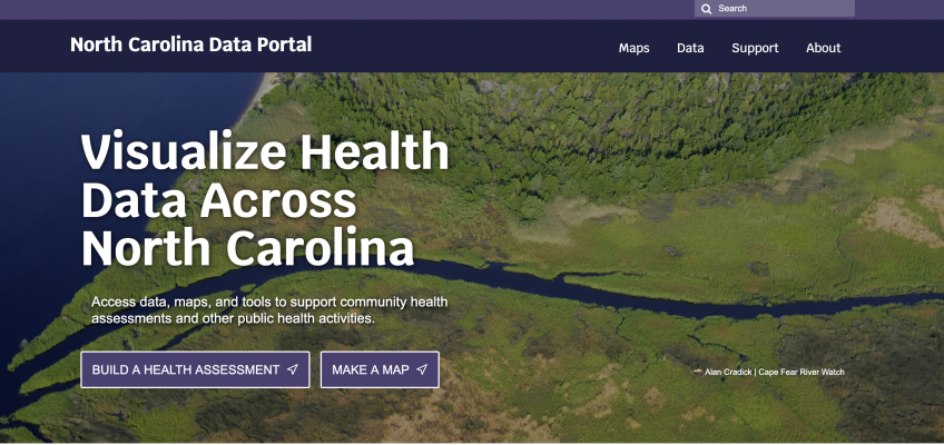 A screenshot of the NC Data Portal homepage. It features an image of green fields and text that reads, " Visualize Health Across North Carolina."