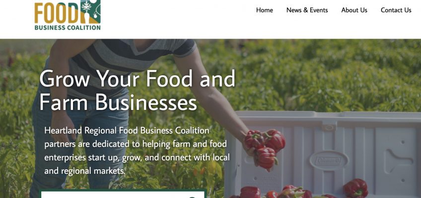 A screenshot of the Heartland Food Business Coalition's homepage. The photo shows a person picking red peppers and placing them into a white cooler.